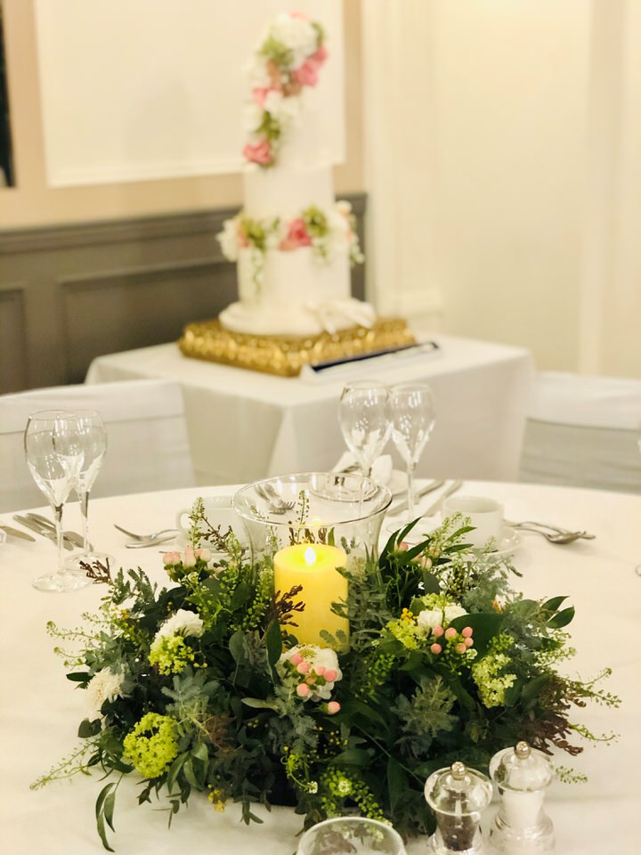 Table centrepiece with candles at a wedding